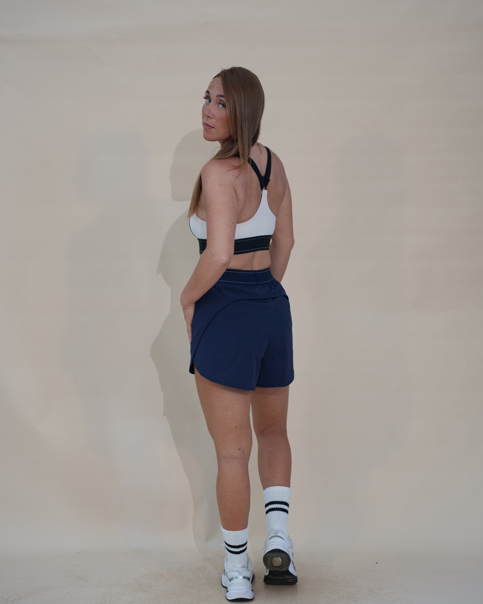 The Jet Set Short — short de running femme The Fit Society, bleu, trois quarts dos